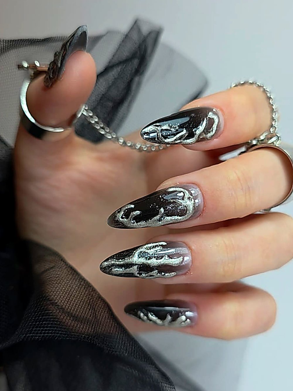 Black almond nails with silver chrome art